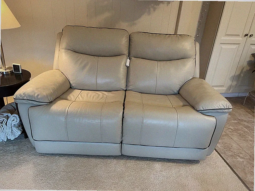This loveseat recliner is,grained leather, cream in color. Firm 600.00